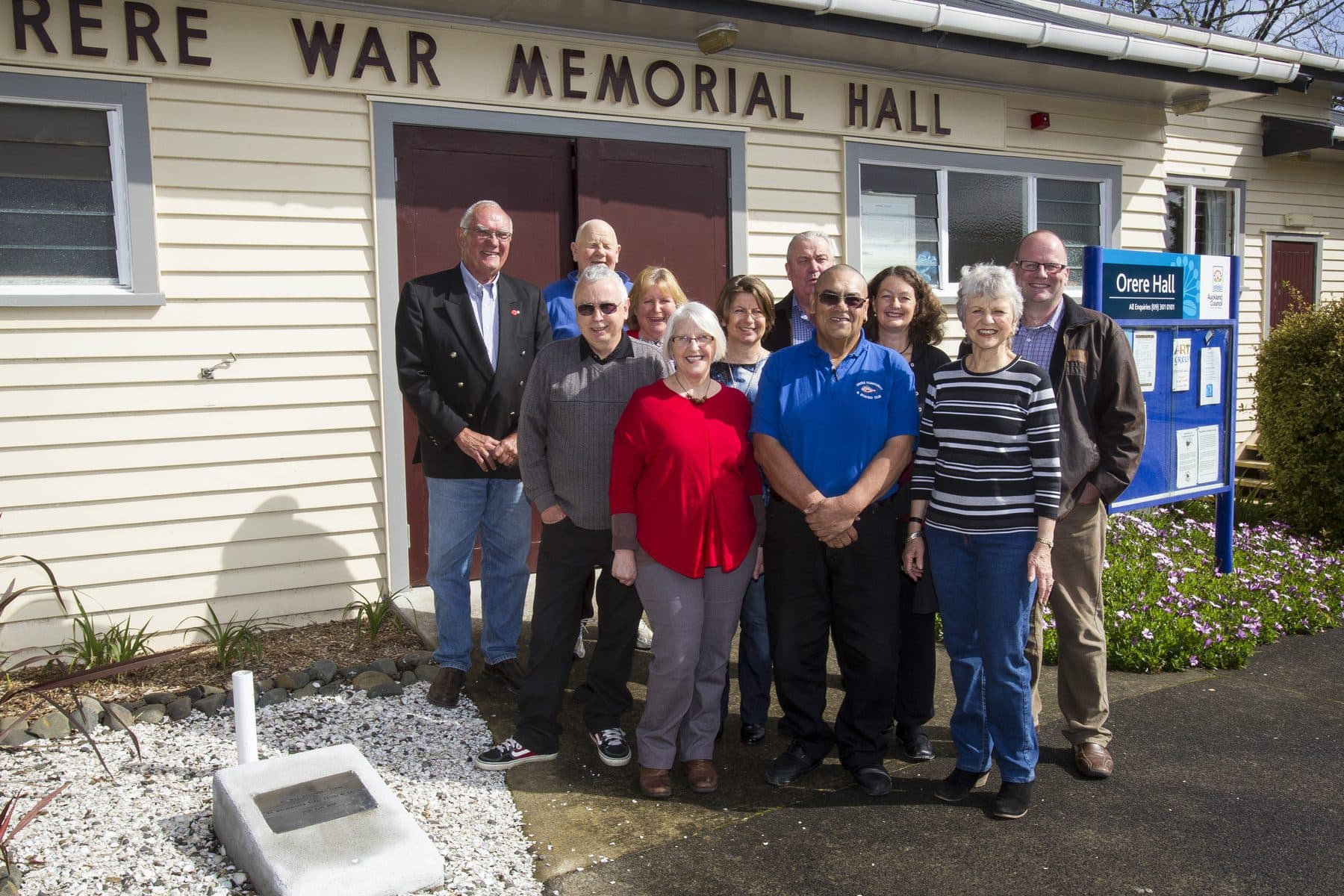 A community group standing together outside the Orere War Memorial Hall.